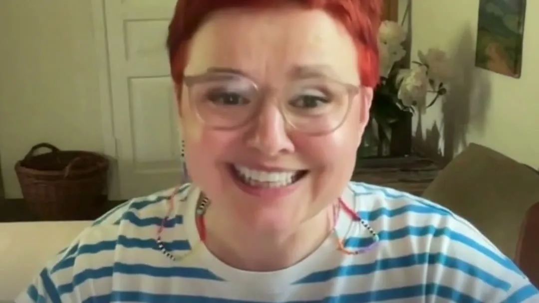Oksana T., programme participant, smiling during a video conversation