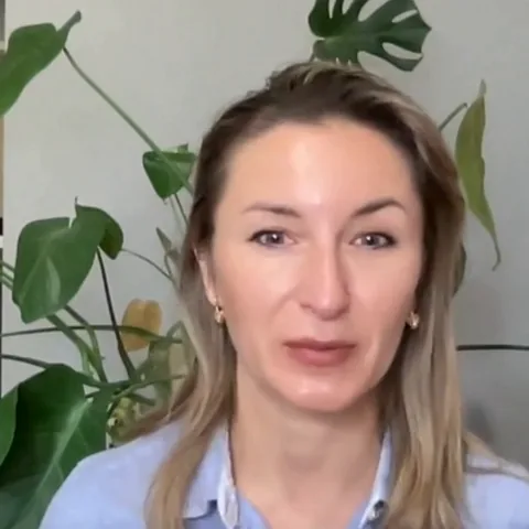 Tatyana, a volunteer mentor, speaking to camera at home