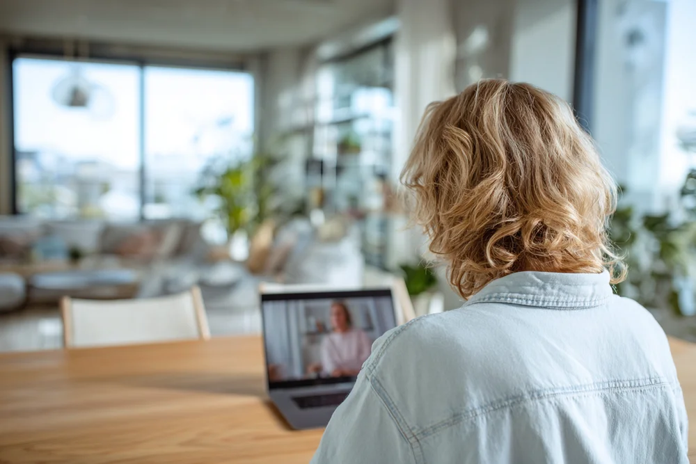 Over the shoulder of a volunteer during a one-to-one video session
